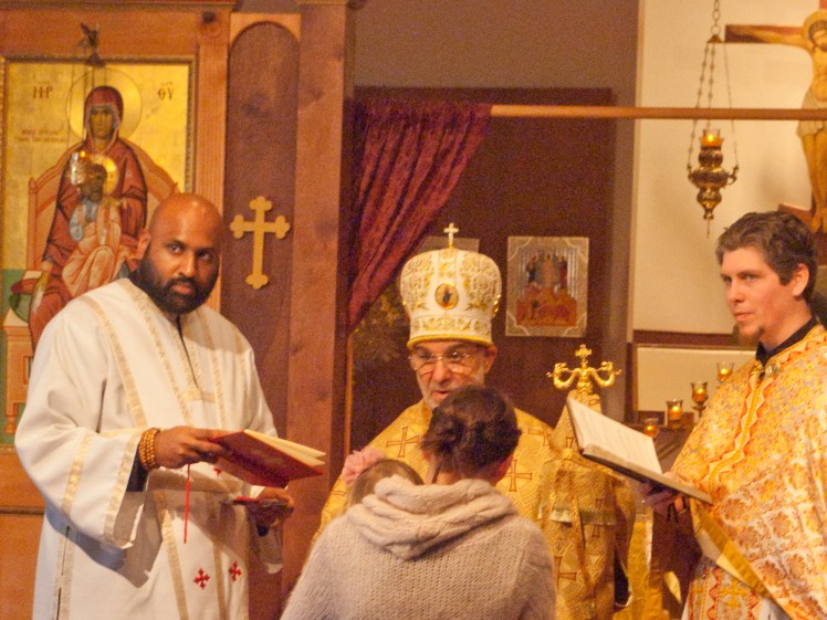 Sdn. Benjamin Daniel, Bishop Thomas, and Fr. James Purdie inducting Carrie Holmes and her daughter into the Order of St. Ignatius (Brad was on duty)